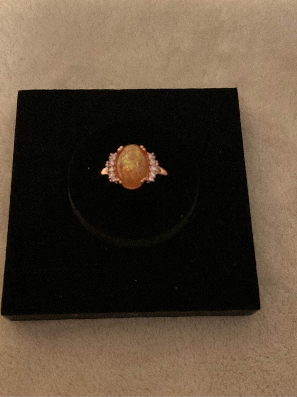 Gold-Tone Ring with Orange Opal Center and Clear Accent Stones